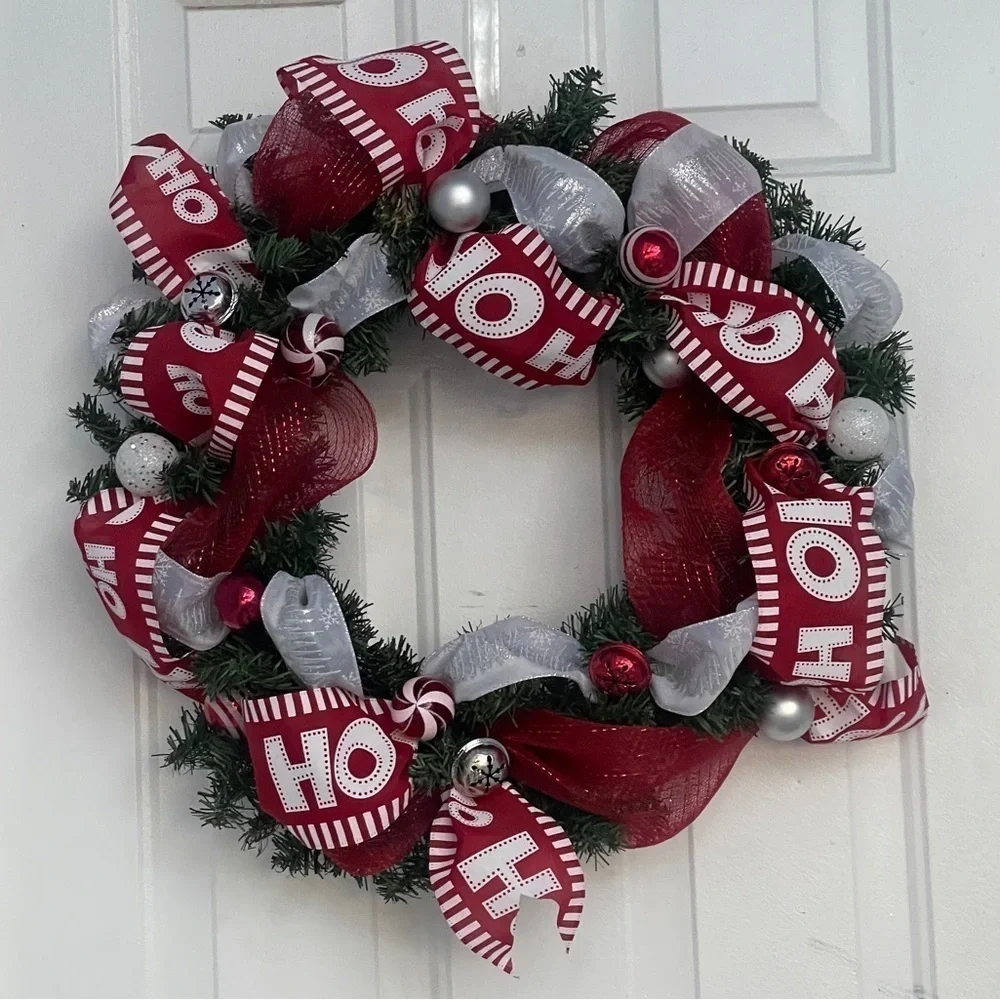 Handmade Christmas wreath, ribbon,bells, and ornaments. Silver, white and red